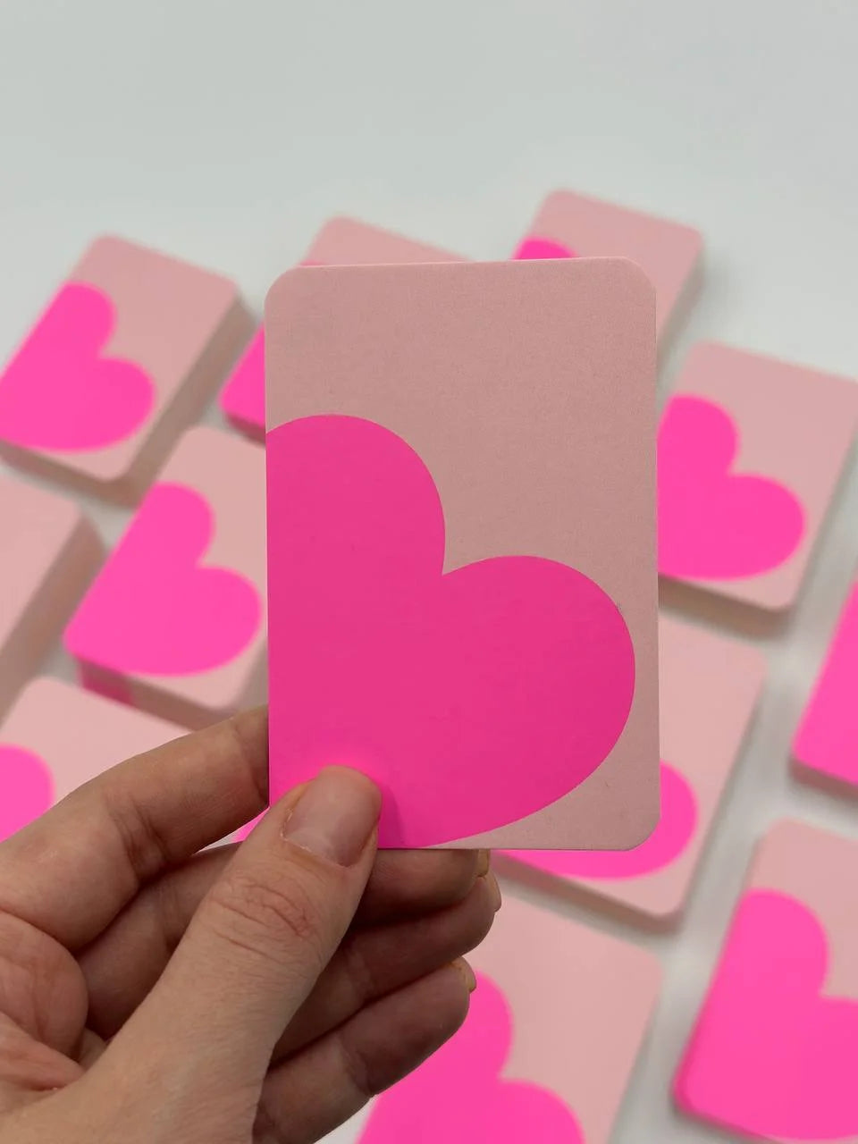 Mini light pink greeting card with a large magenta heart shape cropped at the edges.