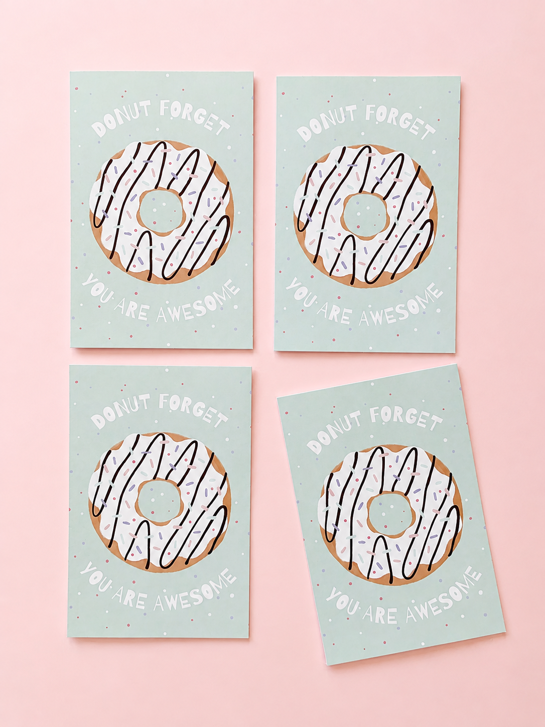 Greeting cards with an illustrated donut and the message “Donut forget you are awesome” on a soft pink background.