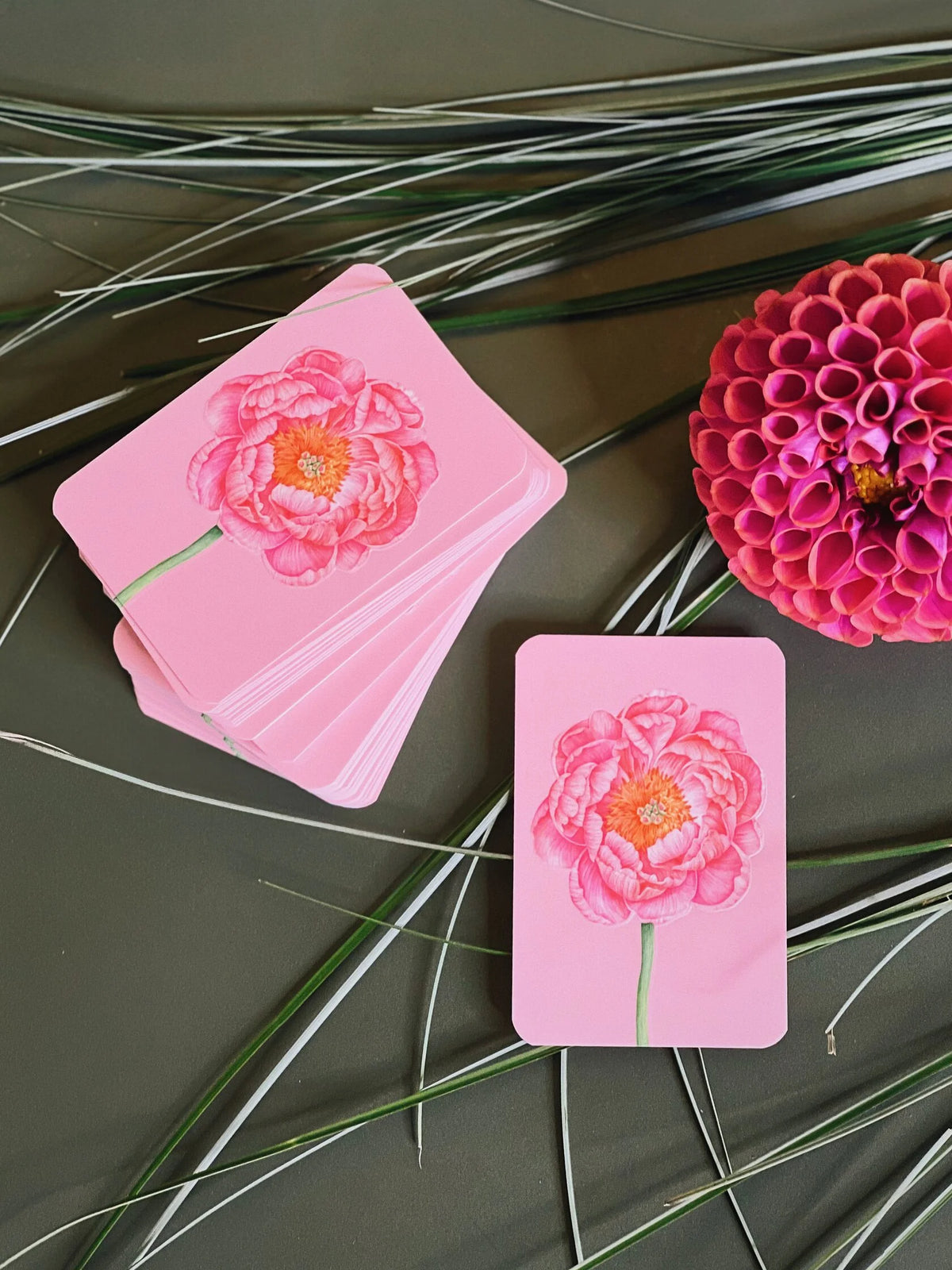 Mini pink greeting card with an embossed botanical illustration of a pink peony flower.