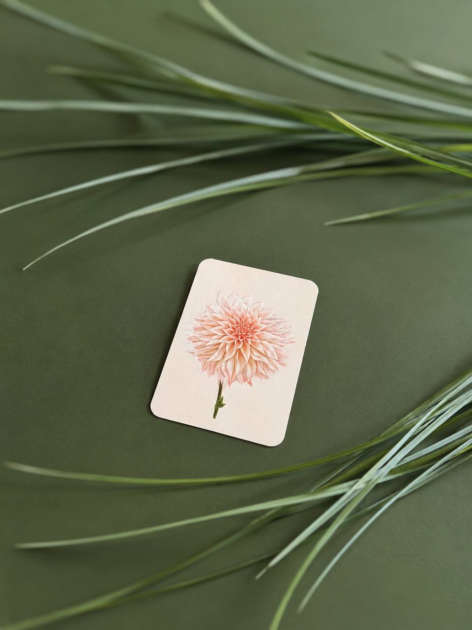 Mini light beige greeting card with an embossed botanical illustration of a dahlia flower.