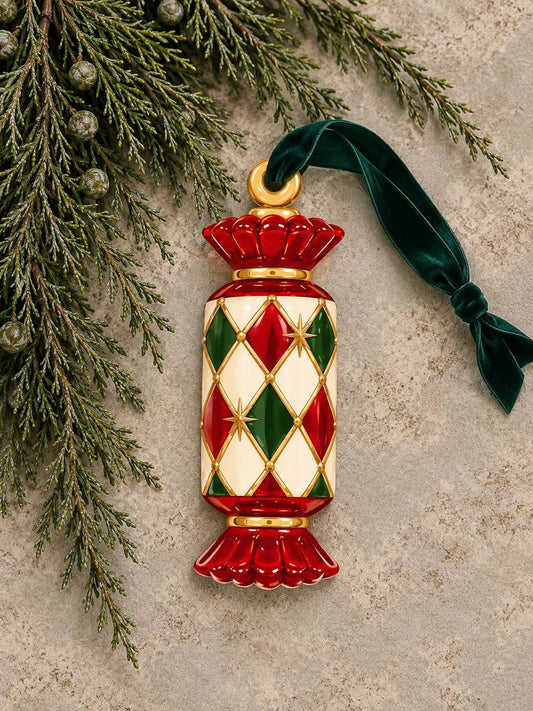 Shaped paper ornament "Circus Candy" with an embossed red, green, and gold jeweled pattern, hung with a green ribbon among pine branches.
